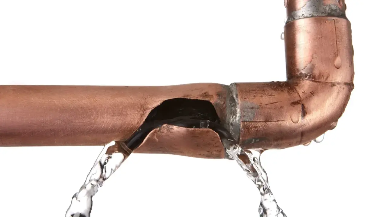 Fuite d'eau sur un tuyau en cuivre endommagé. Une solution pour réparer tuyau cuivre sans soudure est nécessaire.