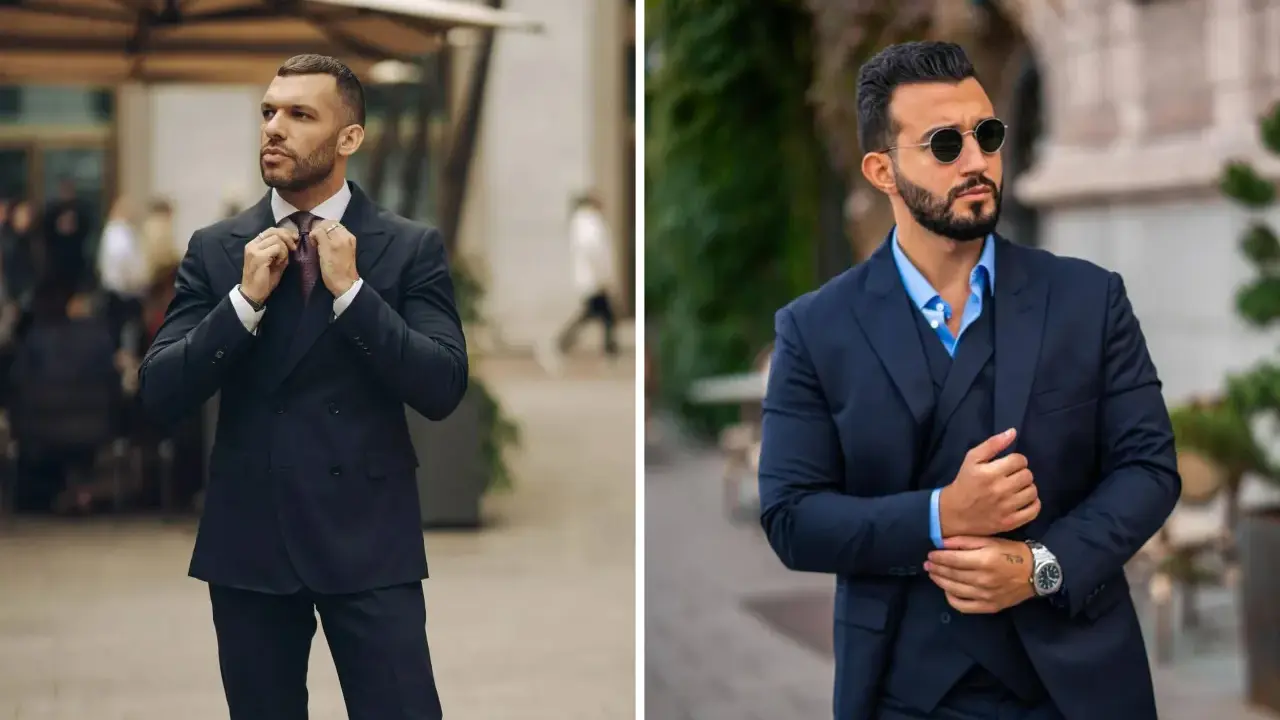 Two men in sharp navy suits, ready for a cocktail attire event. One adjusts his tie, the other sports sunglasses.