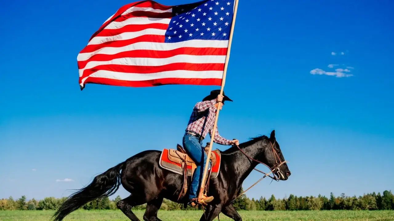 Kowbojka na czarnym koniu niesie flagę USA. To obraz wolności i dzikiego zachodu, pełen ciekawostek o Ameryce.