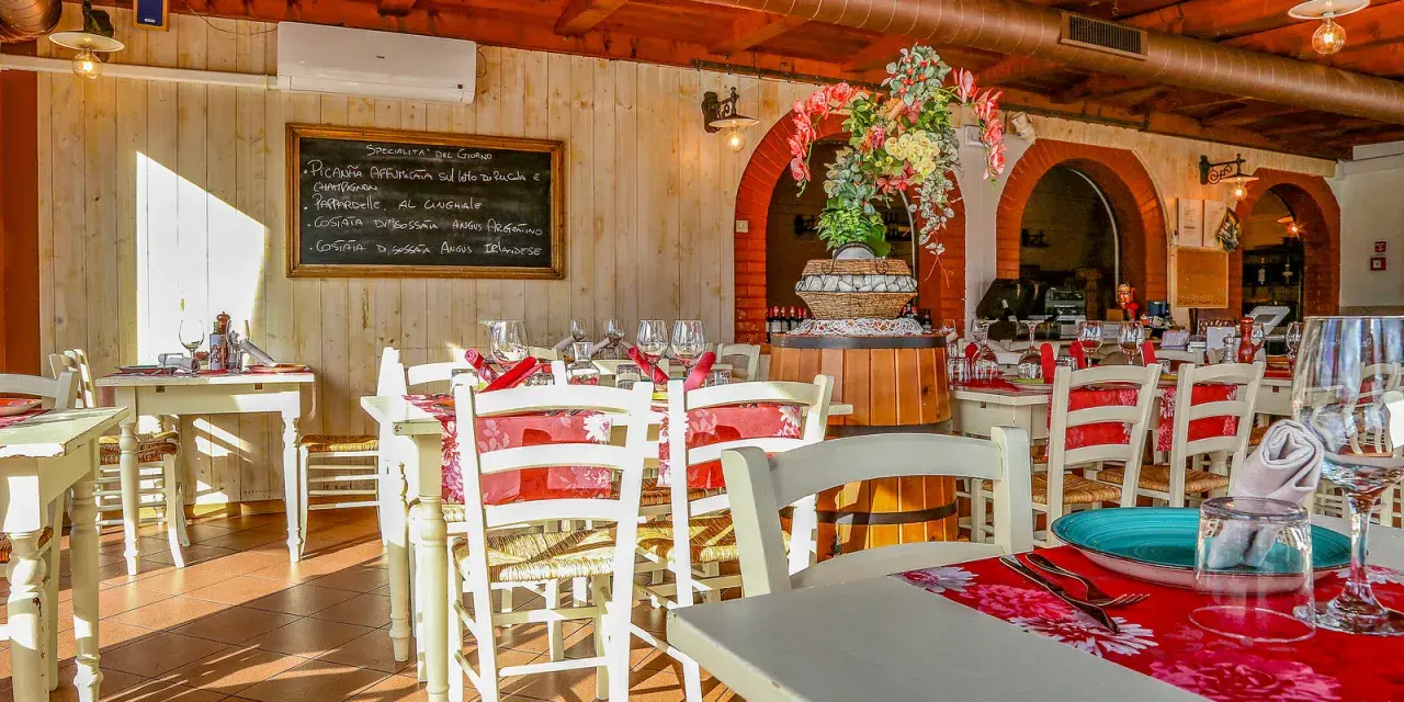 Interno di un ristorante di carne a Rimini centro, con tavoli apparecchiati e un menu scritto a mano.