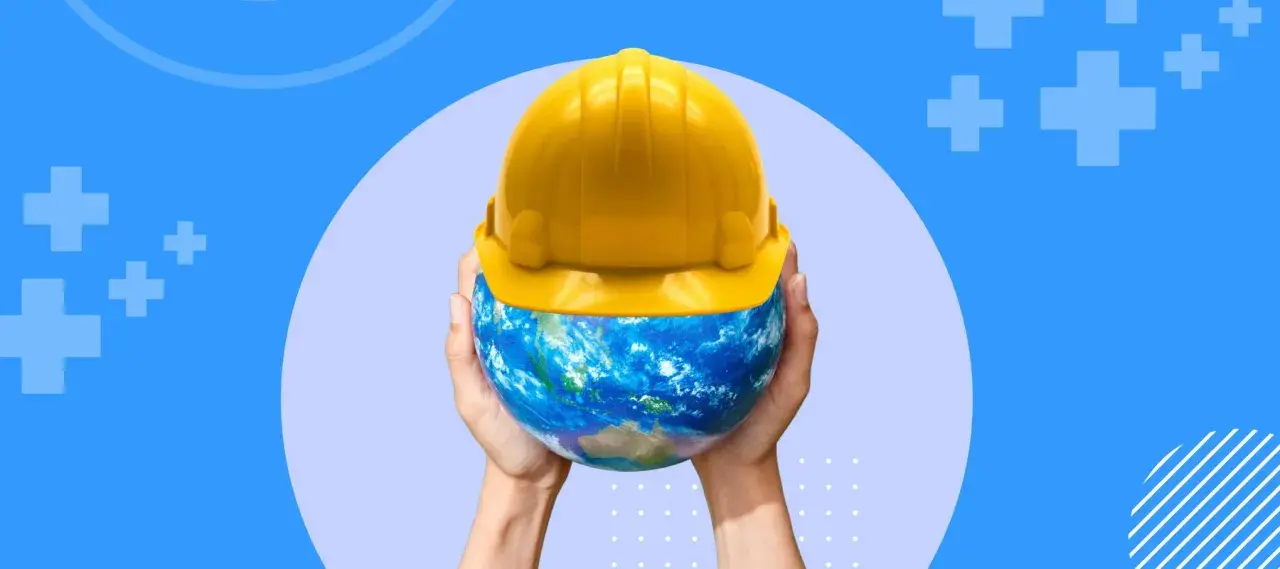 Mains tenant la Terre coiffée d'un casque jaune, symbolisant la sécurité et la réglementation des locaux de travail à l'échelle mondiale.