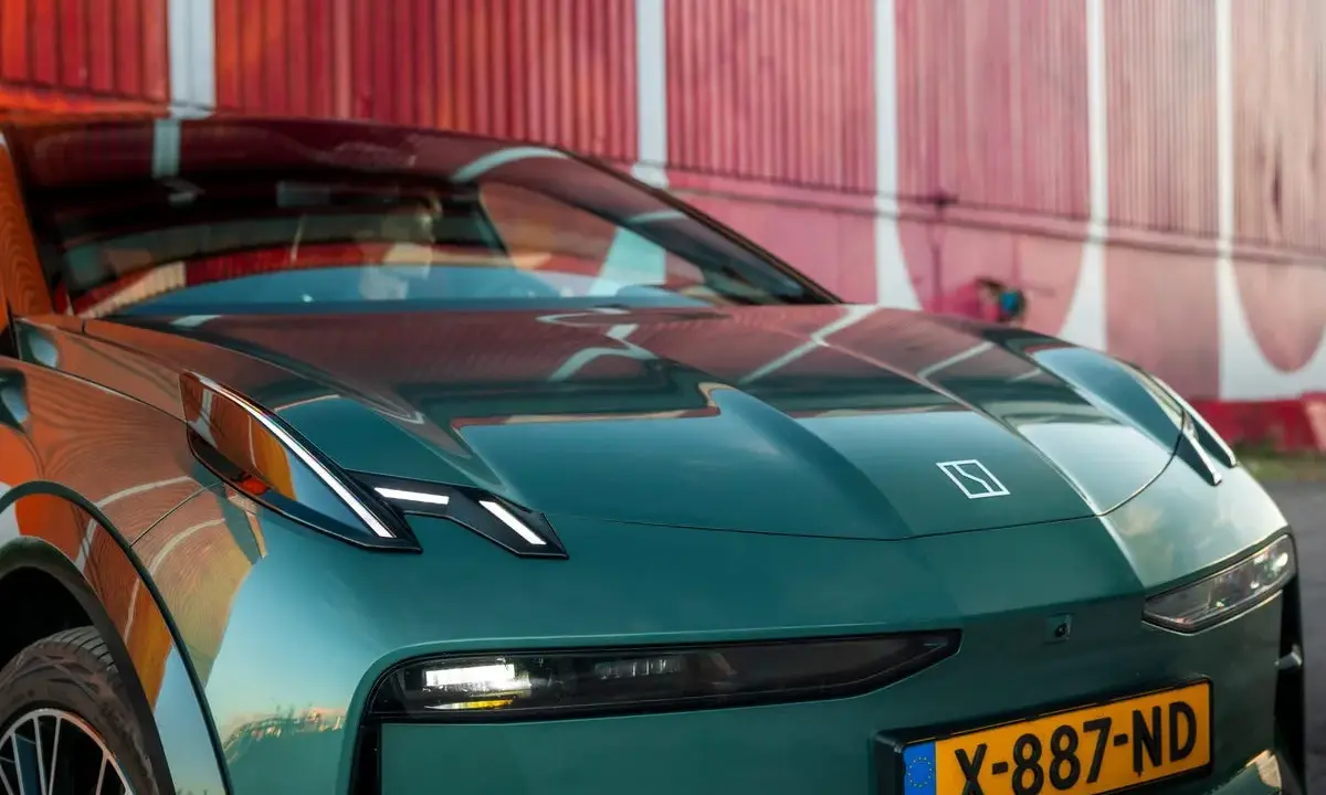 El elegante Zeekr X, un coche eléctrico verde oscuro, se exhibe con su distintivo logo y faros LED, listo para la aventura.