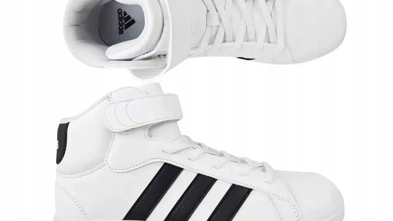 Białe buty sportowe Adidas z czarnymi paskami i rzepem. Idealne dla każdego, kto ceni wygodę i styl, jak wszystkie modele butów adidas.
