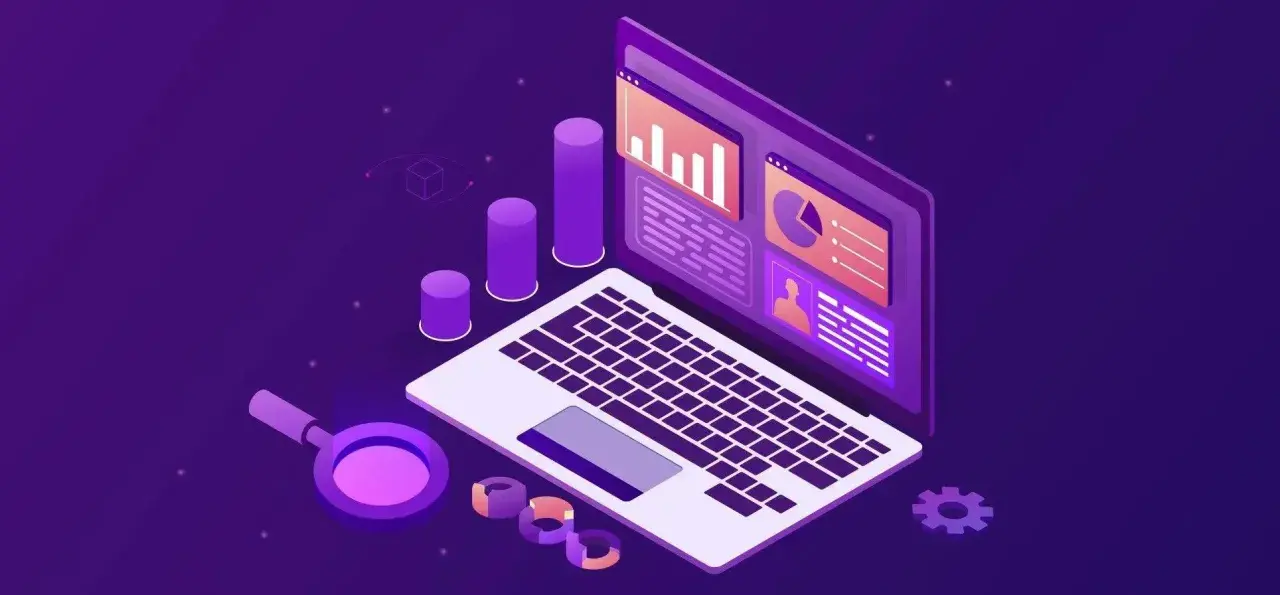 Laptop z wykresami i lupą, symbolizujące analizę danych w trendy ecommerce.
