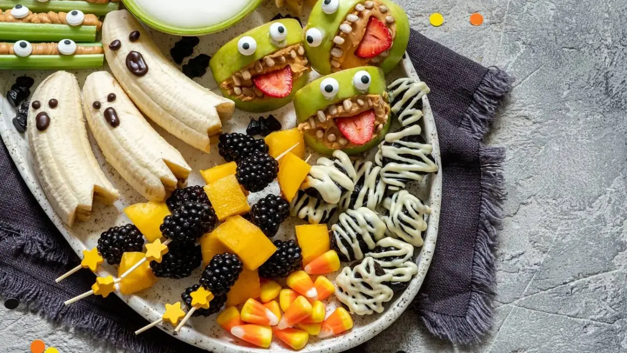 Brochetas de frutas y dulces para Halloween: plátanos fantasma, manzanas monstruosas y moras. ¡Una fiesta terroríficamente deliciosa!
