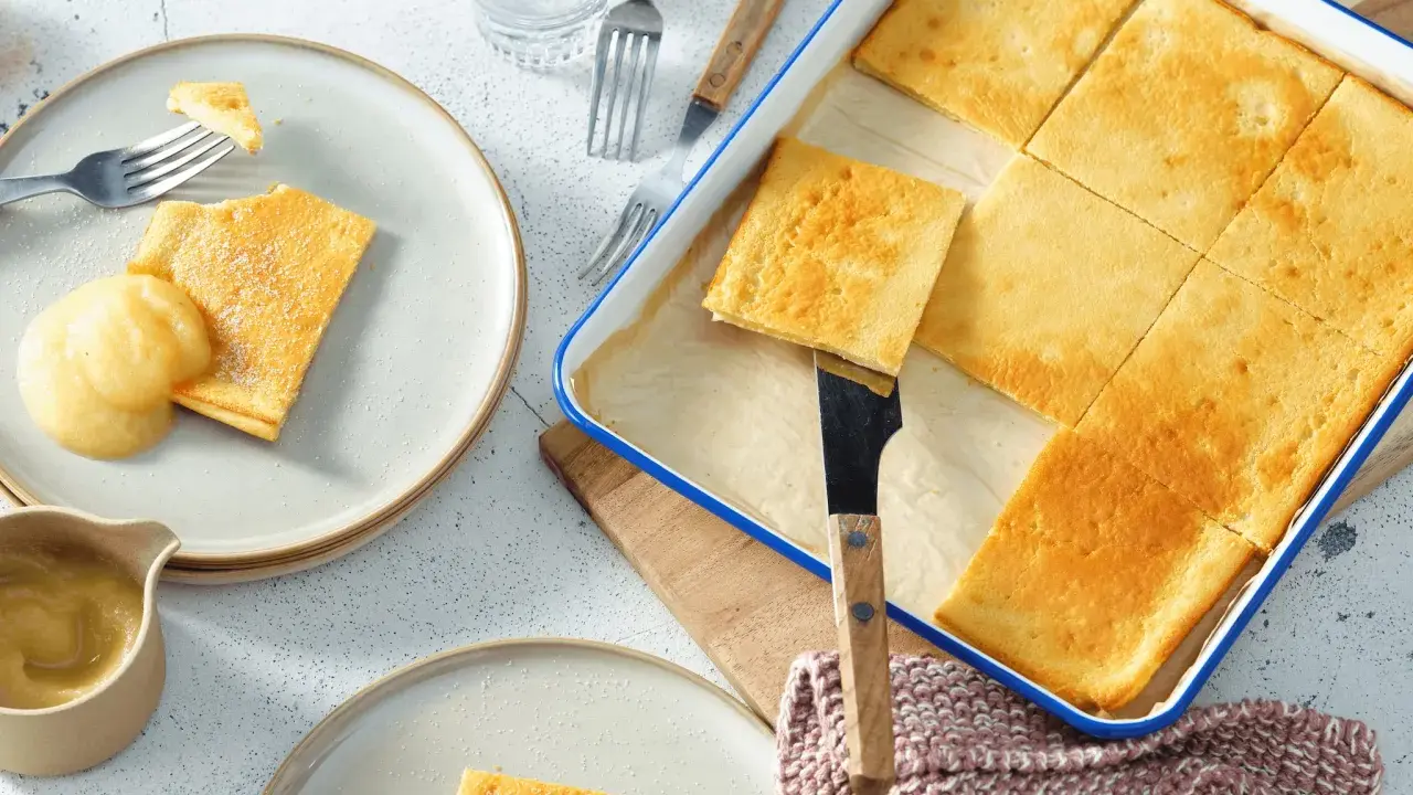Goldbraune Pfannkuchen vom Blech, frisch aus dem Ofen, werden mit Apfelmus serviert. Ein Genuss für die ganze Familie!