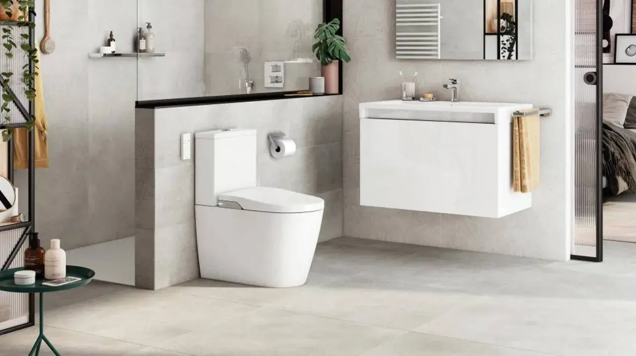 Modern bathroom with toilet and sink. A sleek design that makes you want to quitar bidet.