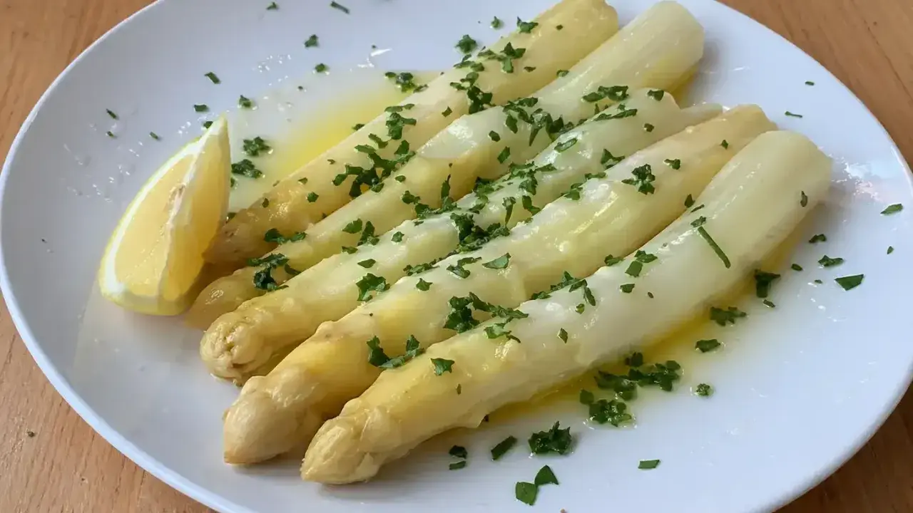 Vitt sparris med smält smör, persilja och en citronklyfta. Perfekt sparris koktid för en lätt och god rätt.