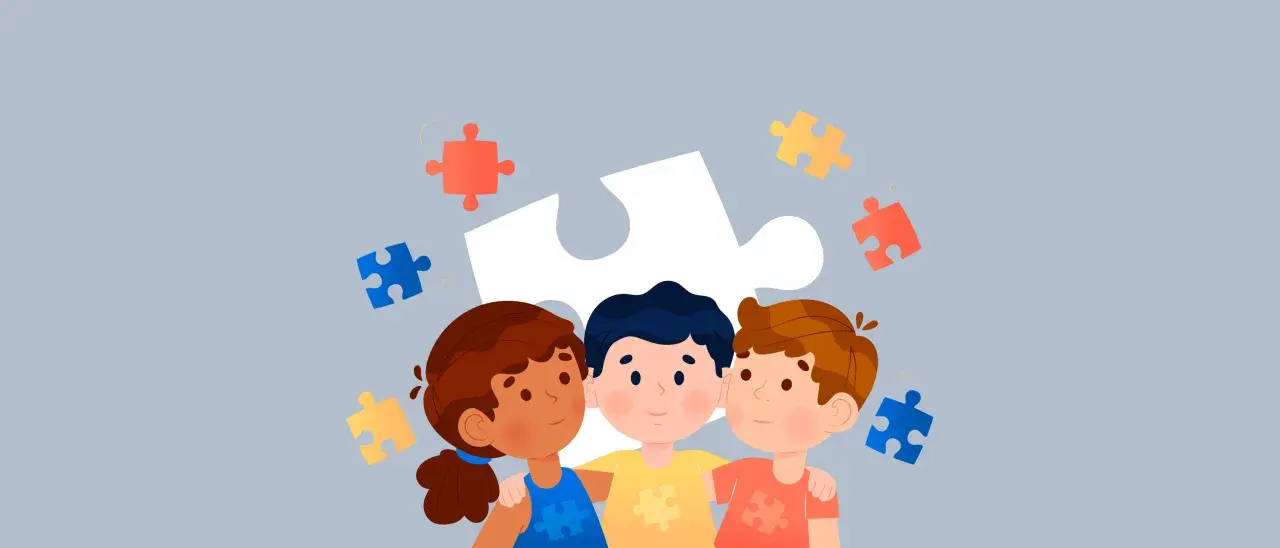 Tres niños se abrazan, rodeados de piezas de rompecabezas. Una guía para como evaluar a un niño con autismo en la escuela.