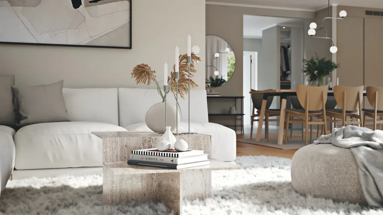 En modern lounge med en vit soffa, ett soffbord i sten och en fluffig matta. I bakgrunden syns en matsal med trästolar, vilket visar olika inredningsstilar.