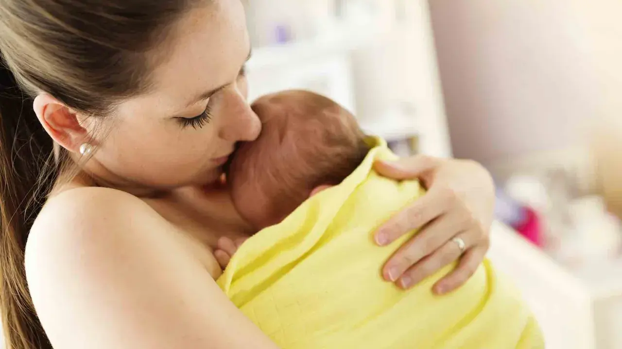 Un tenero abbraccio tra madre e neonato, un esempio di attaccamento alla madre psicologia, che crea un legame indissolubile.