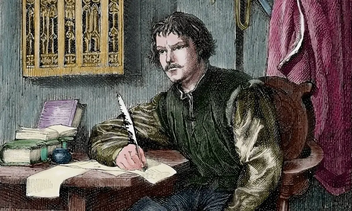 Martin Luther schreibt mit einer Feder. Wann wurde Martin Luther geboren? Die Frage beschäftigt Historiker seit Jahrhunderten.