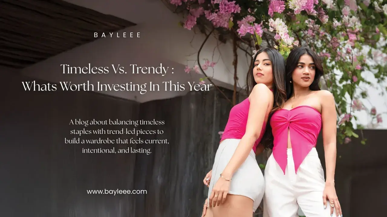 Two women showcase modern fashion couture, one in a pink tube top and white shorts, the other in a pink knotted top and white pants, against a backdrop of pink flowers.