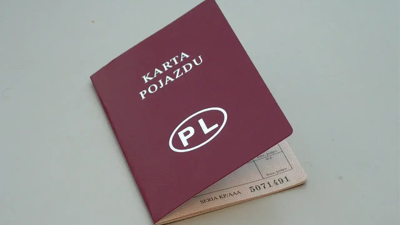 Czerwona karta pojazdu z białym napisem "PL" i numerem seryjnym. Dokument jest otwarty, ukazując dane pojazdu.