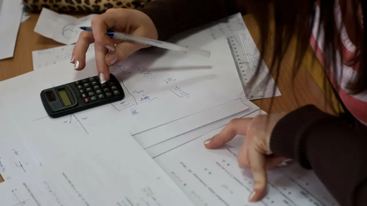 Uczeń rozwiązuje zadania z matematyki, licząc na kalkulatorze. Każdy punkt na egzaminie ósmoklasisty to cenny procent wiedzy.