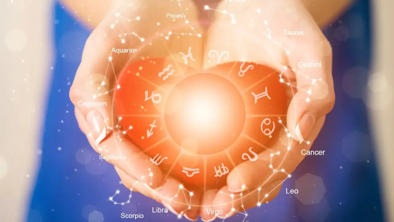 Dłonie trzymające serce z symbolami zodiaku. Sprawdź swój horoskop na jutro miłosny i odkryj, co gwiazdy przygotowały dla Ciebie.