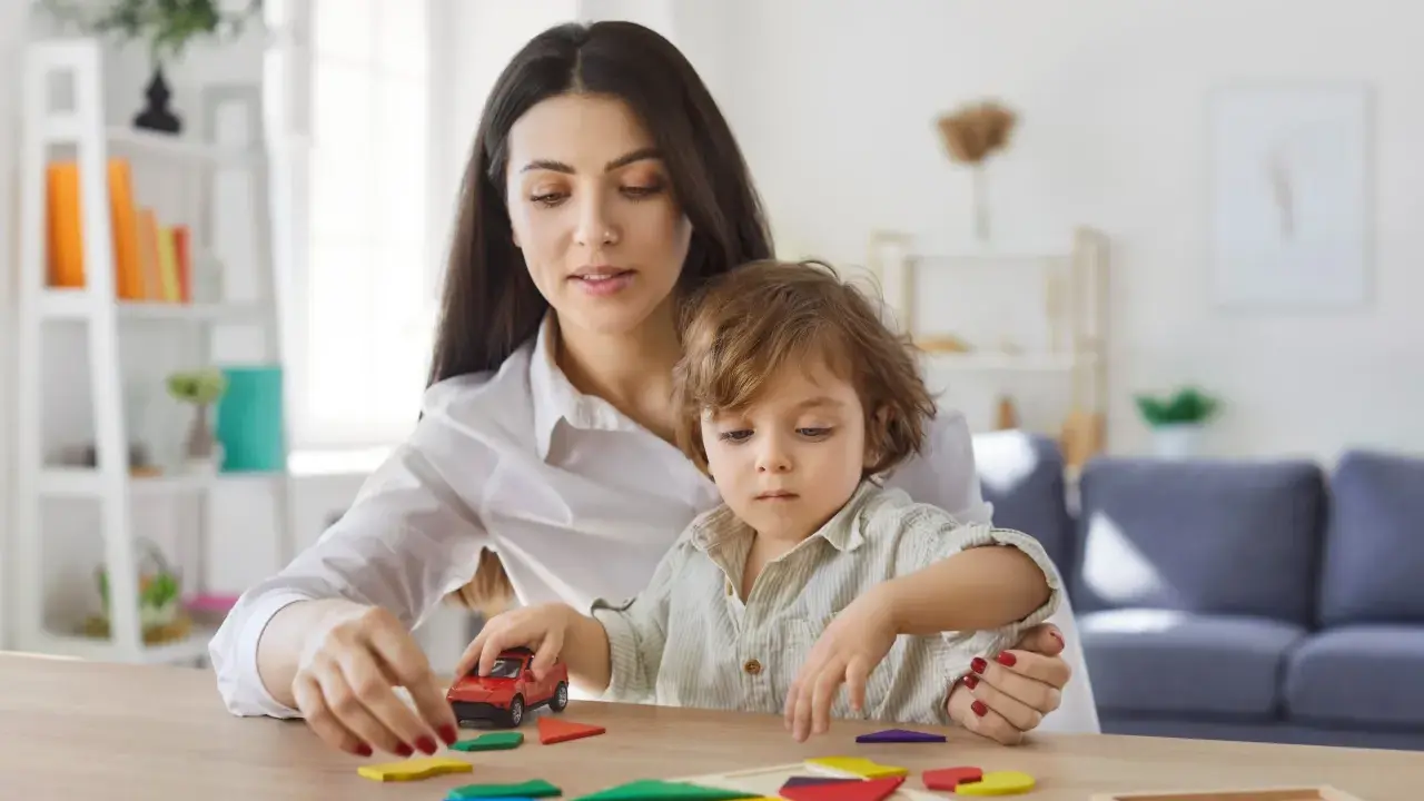 Mama i dziecko bawią się klockami. Zastanawiasz się, ile może zarobić dziecko, żeby nie stracić alimentów?