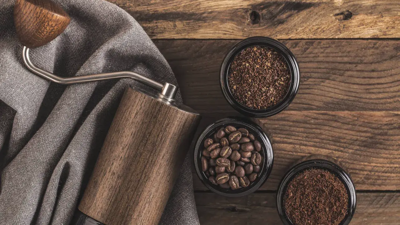 Holz-Kaffeemühle mit drei Behältern: ganze Bohnen, grob gemahlener und feiner, kleiner brauner Kaffee.