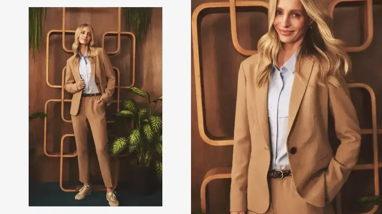 Elegancka stylizacja: jakie spodnie do jasnej marynarki? Modelka prezentuje beżowy garnitur z błękitną koszulą i sneakersami.