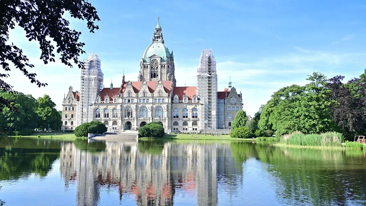 Das Neue Rathaus in Hannover spiegelt sich im Maschsee. Hier kann man viel entdecken, was man in Hannover machen kann!