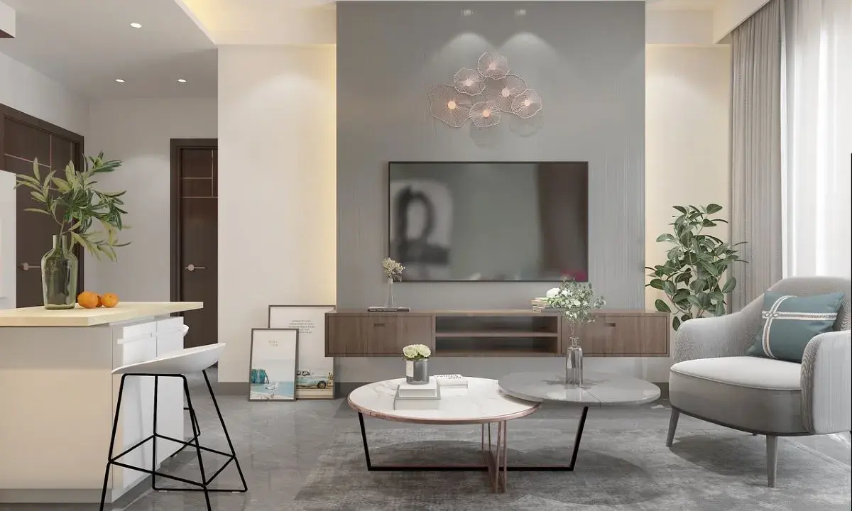 Soggiorno moderno con divano grigio, tavolini rotondi e decorazioni floreali. I colori da abbinare al grigio perla includono tocchi di verde e arancio.
