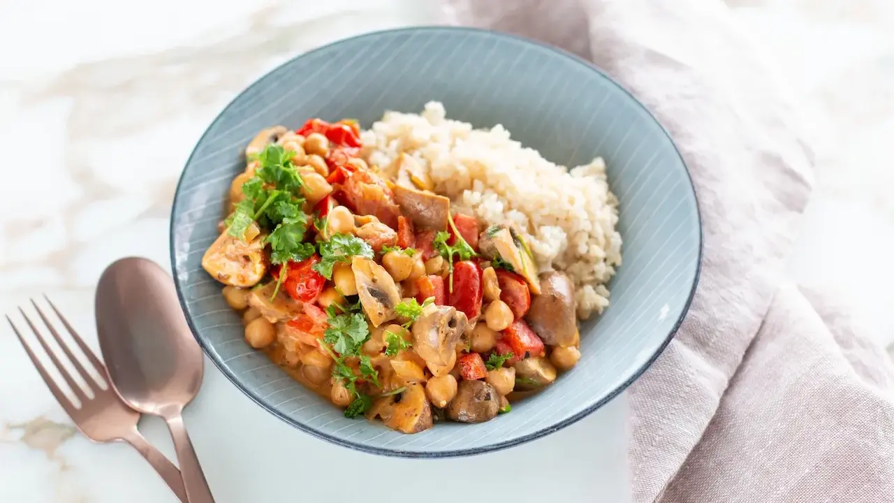 Herzhaftes Gericht mit Kichererbsen, Pilzen und Tomaten, serviert mit Reis. Perfekt für proteinreiche Rezepte.