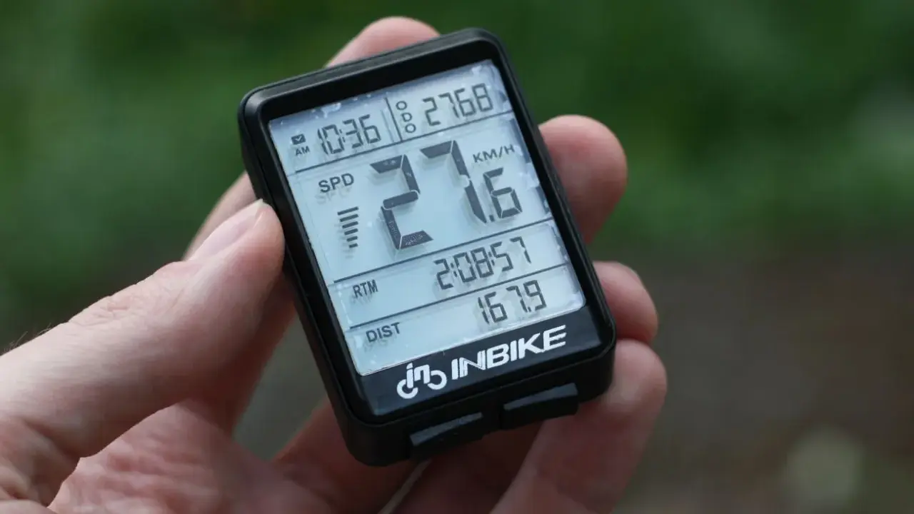 Komputerek rowerowy INBIKE pokazuje 27.6 km/h, 10:36, 2:08:57 i 167.9 km.
