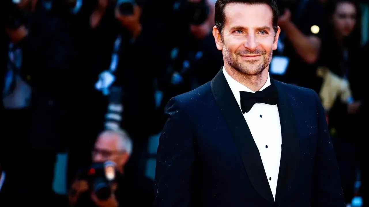 Bradley Cooper smiles, sporting a classic tuxedo. This image confirms that black tie does indeed mean tuxedo.