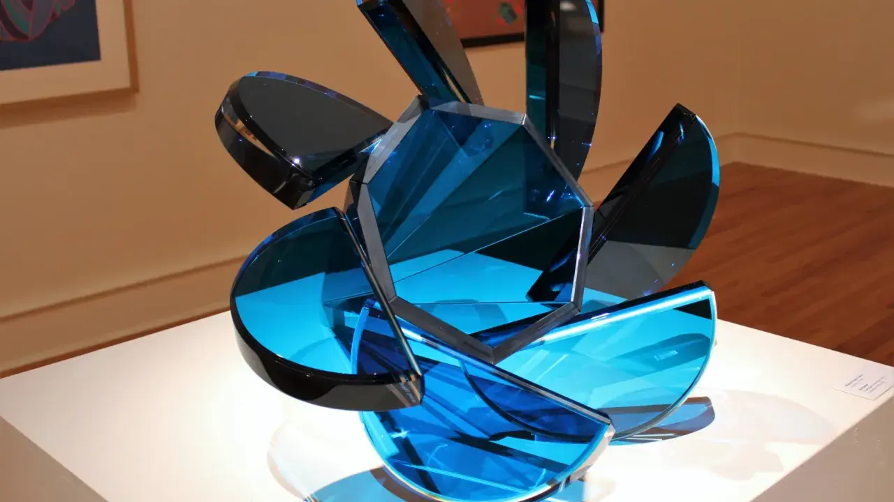 A sculpture of blue glass shards, showcasing transparency in art, with light reflecting through its facets.