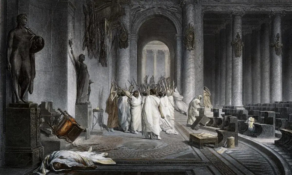 Die Ermordung Caesars: Senatoren mit erhobenen Dolchen umringen den gefallenen Diktator. Ein umgestürzter Stuhl und eine Leiche auf dem Boden zeugen vom brutalen Ende.