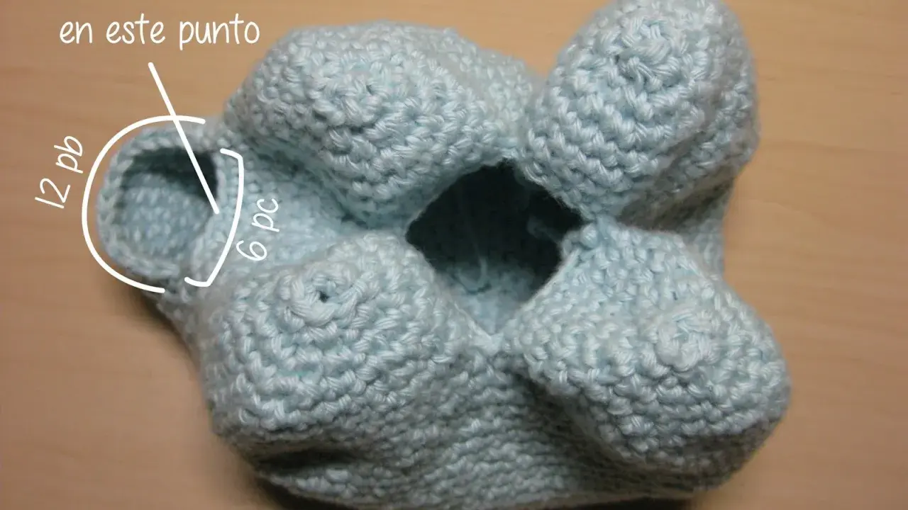 Un elefante amigurumi azul claro, en proceso de tejido. Se indica dónde empezar la trompa.