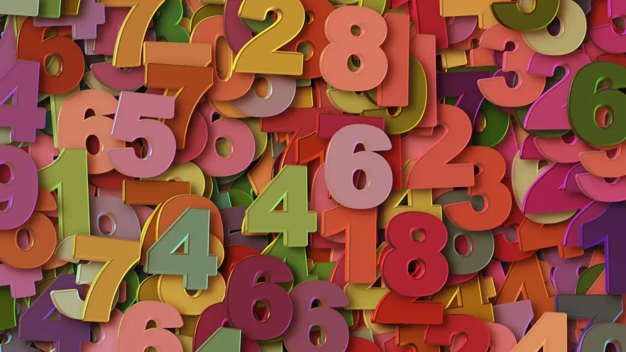 Kolorowe cyfry tworzą gęsty wzór. Wśród nich wyróżnia się liczba 2, symbolizująca rok numerologiczny 2, zachęcając do harmonii i współpracy.
