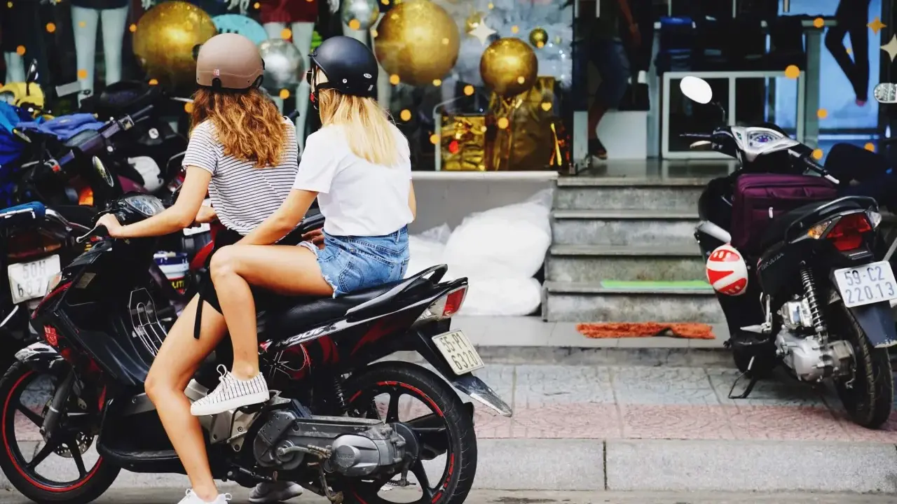 Dos chicas con cascos en una moto, listas para sacar carnet moto y disfrutar de la libertad.