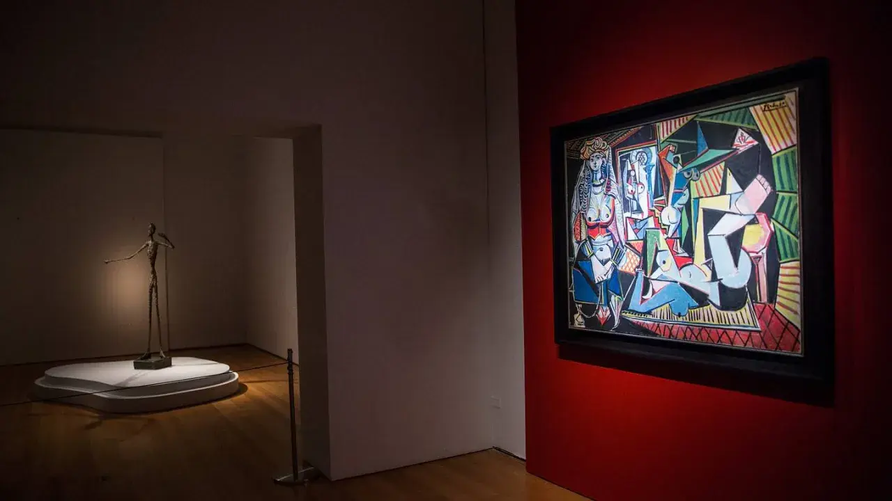 A museum gallery showcases Picasso's "Les Femmes d'Alger" alongside a slender bronze sculpture.