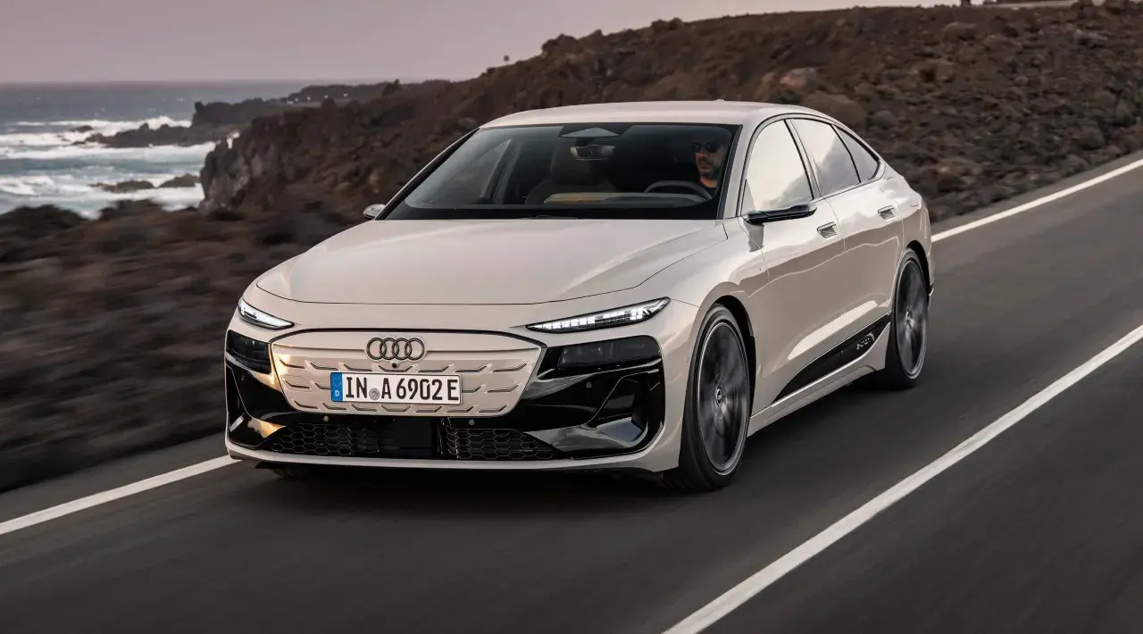 Eleganckie Audi A6 e-tron sunie po malowniczej drodze nad oceanem.