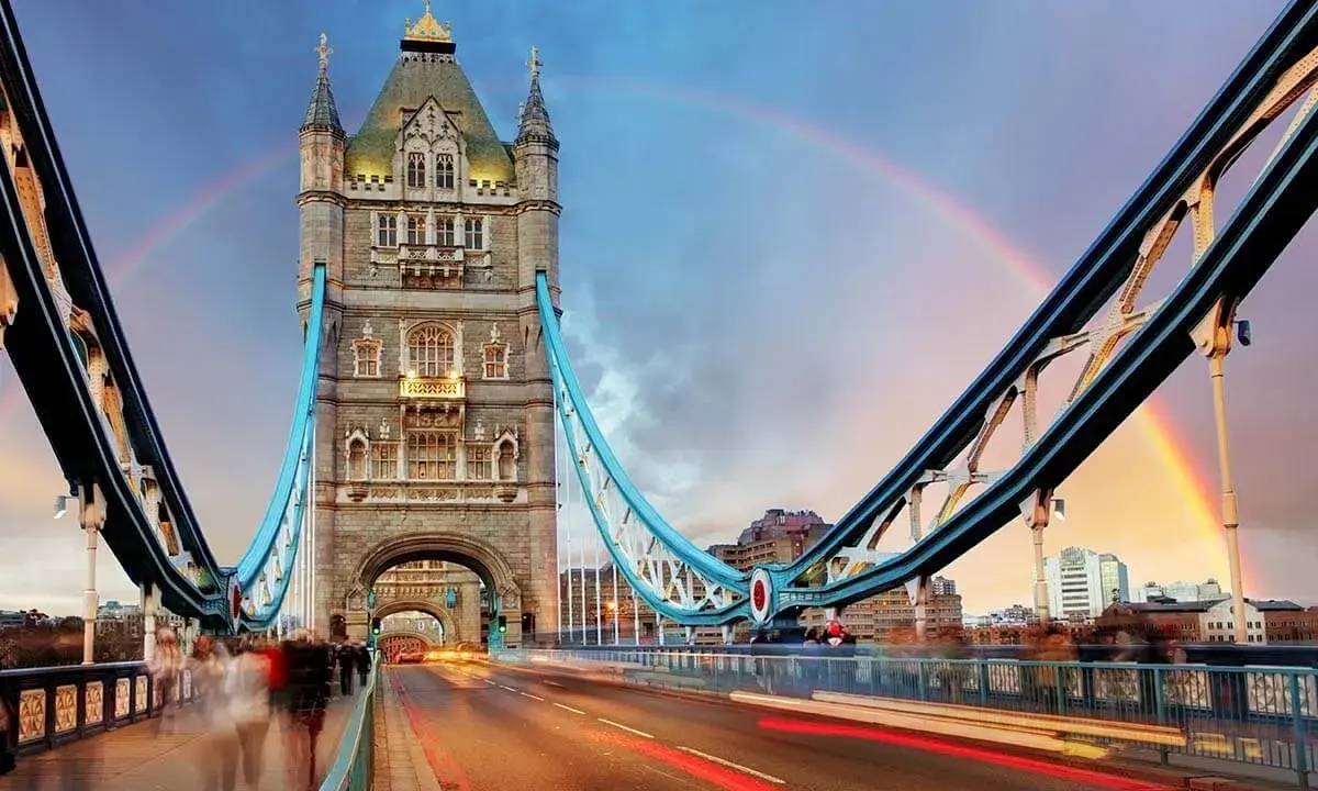 Tower Bridge in London, a city renowned for its art, glows under a double rainbow at dusk.