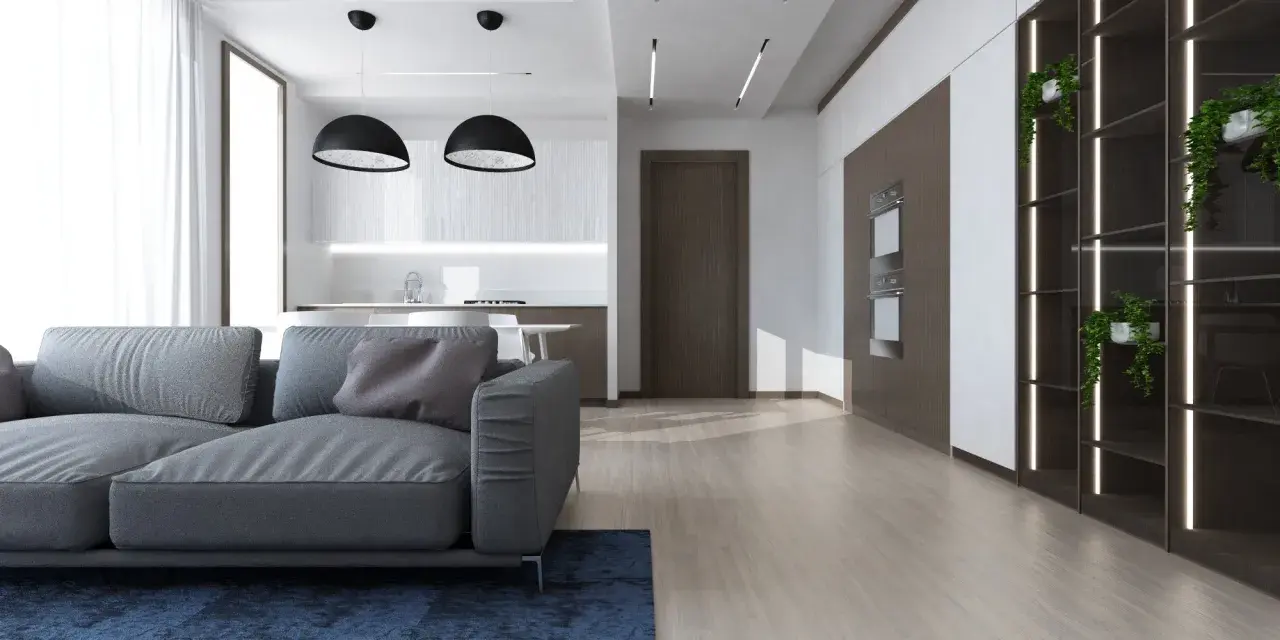 Soggiorno moderno con divano grigio, cucina a vista e scaffalatura illuminata. Ottime idee controsoffitto open space per definire gli ambienti.