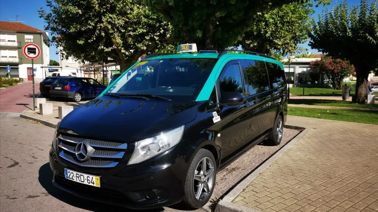 Schwarzer Mercedes-Taxi-Van mit türkisfarbenem Dach in Lissabon. Informieren Sie sich über die Taxi Lissabon Kosten für Ihre Fahrt.
