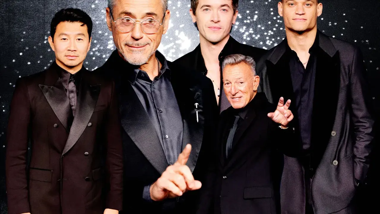 Five men in black suits with black shirts pose for a photo.