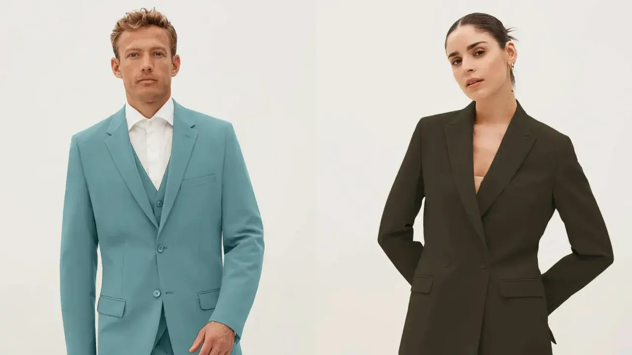 Man in teal single-breasted suit with vest, woman in dark green double-breasted blazer.