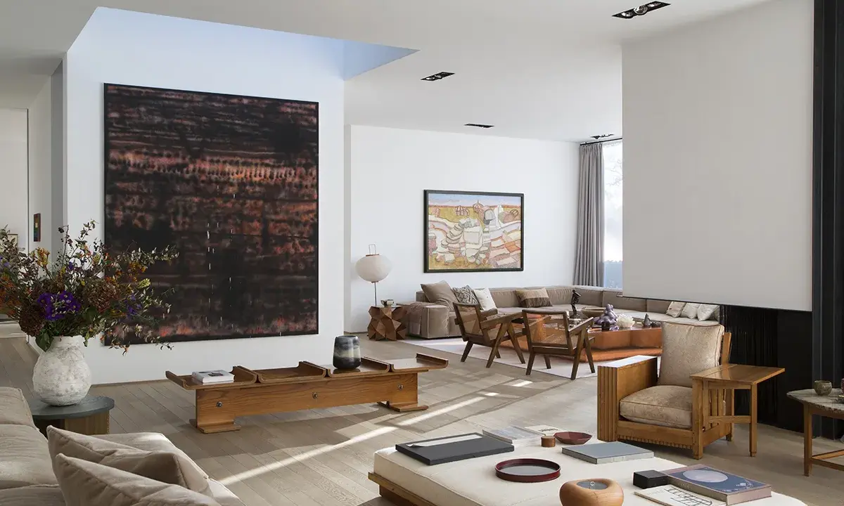 A spacious living room with modern art, including a large abstract piece by tiqui atencio.