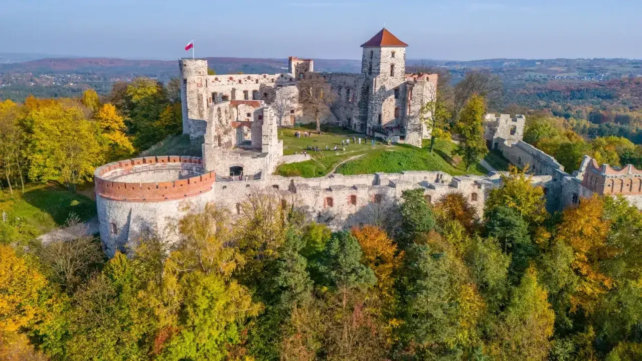 Ruiny zamku na wzgórzu, otoczone jesiennym lasem. Piękny krajobraz Jury Krakowsko-Częstochowskiej.