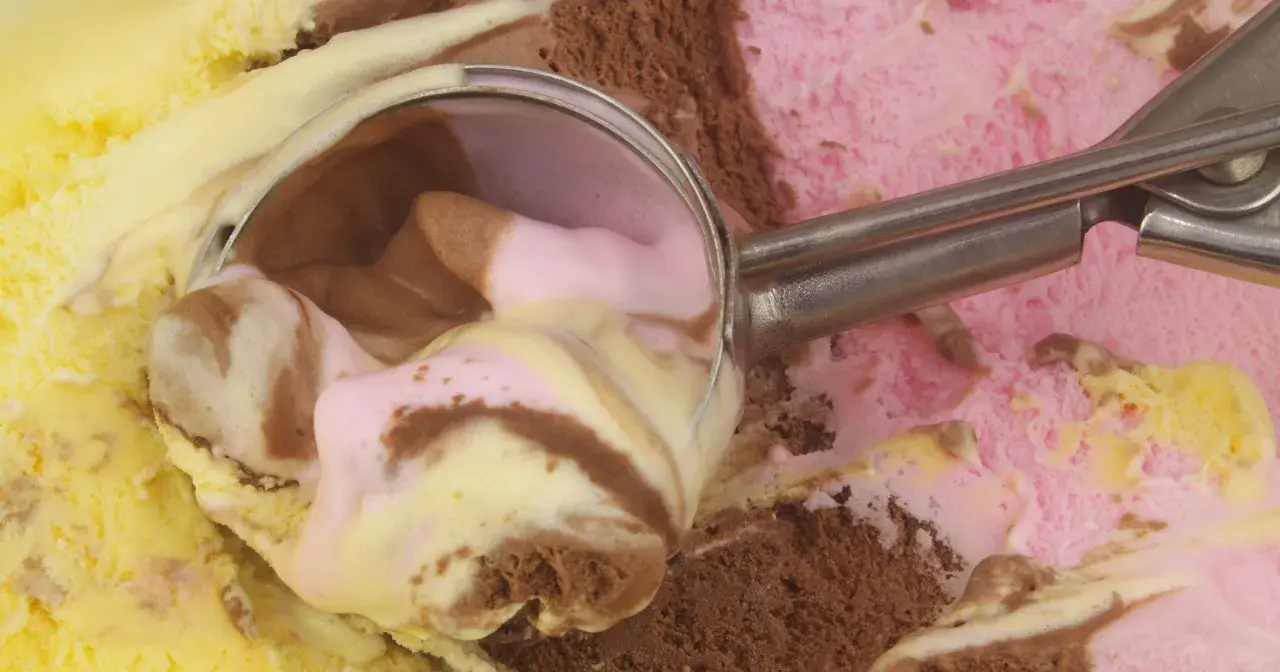 Łyżka do lodów nabiera porcję pysznego, kolorowego gelato. Czy to czekoladowe, truskawkowe, czy waniliowe?