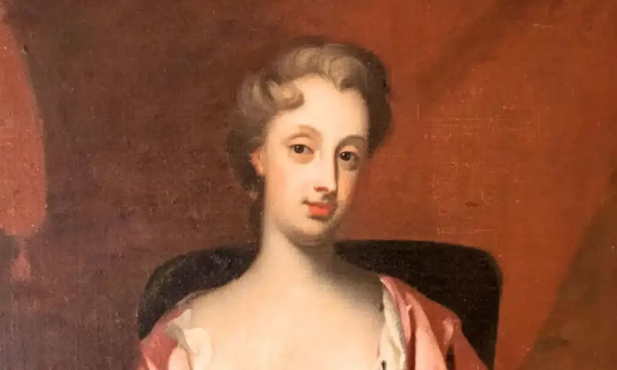 Porträtt av Christina Piper i rosa klänning, med en mjuk blick och uppsatt hår.