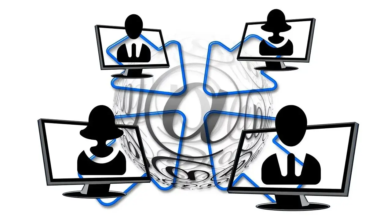 Vier Monitore mit Silhouetten von Personen, verbunden durch blaue Linien, umgeben von einem großen @-Symbol. Dies symbolisiert die Vernetzung und die Bedeutung von Online-Kommunikation, aber auch die Gefahr von "hijacking" – der Übernahme von Accounts.