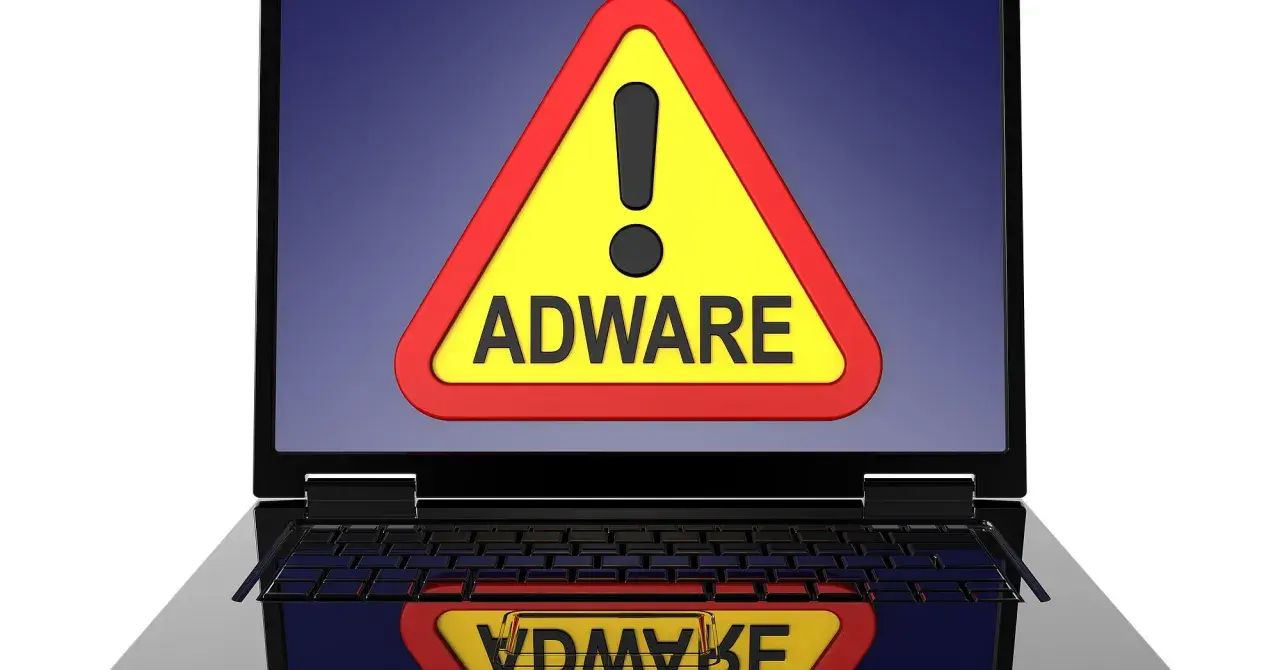 Warnung auf Laptop-Bildschirm: gelbes Dreieck mit Ausrufezeichen und dem Wort "ADWARE". Ein Adware-Virus ist eine Bedrohung.