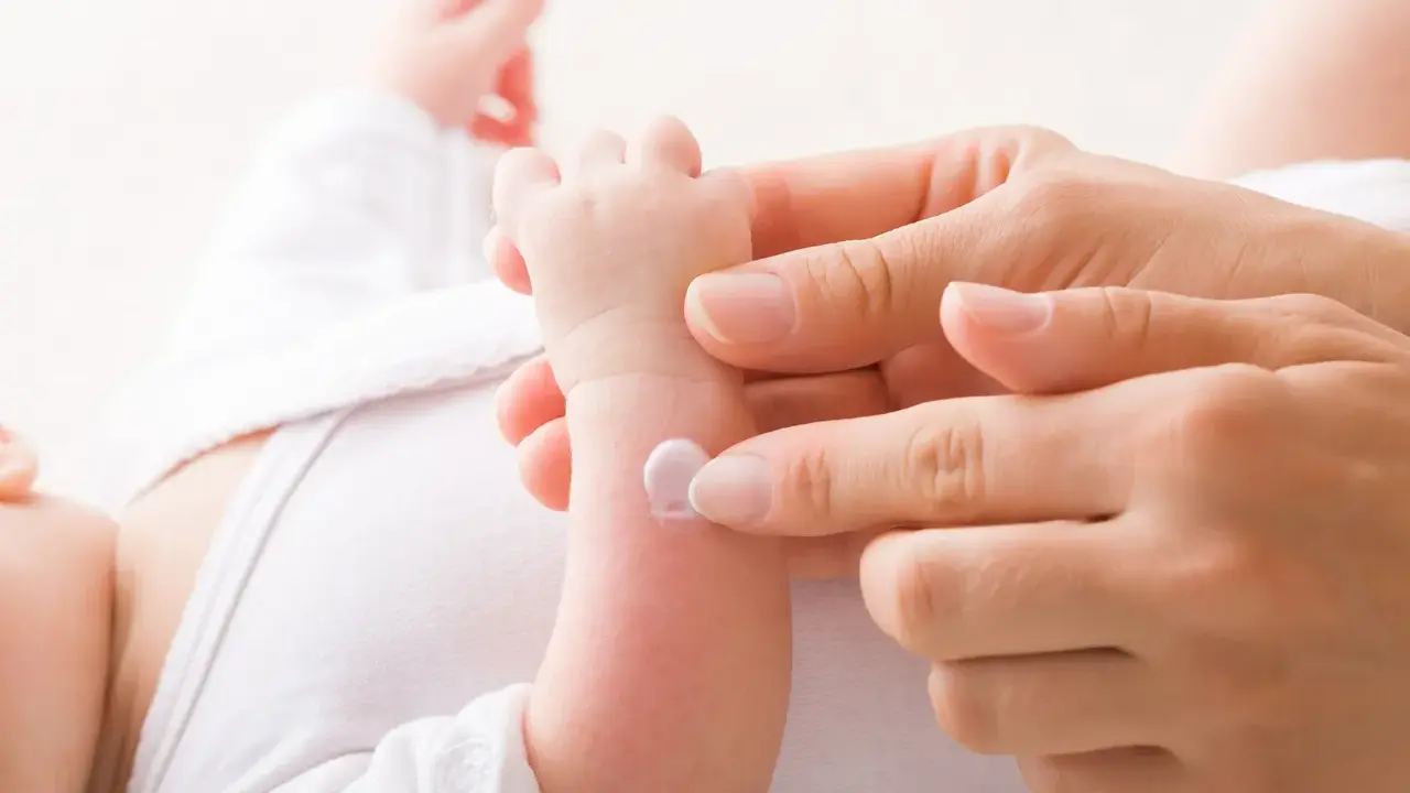 Application de cicalfate nourrisson sur le bras d'un bébé par une main douce.