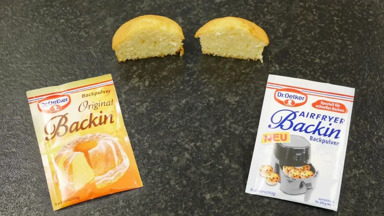 Zwei Päckchen Dr. Oetker Backin, einmal Original und einmal für den Airfryer, liegen neben zwei halbierten Küchlein. Perfekt für schnelles Backen mit Mehl und Backpulver.