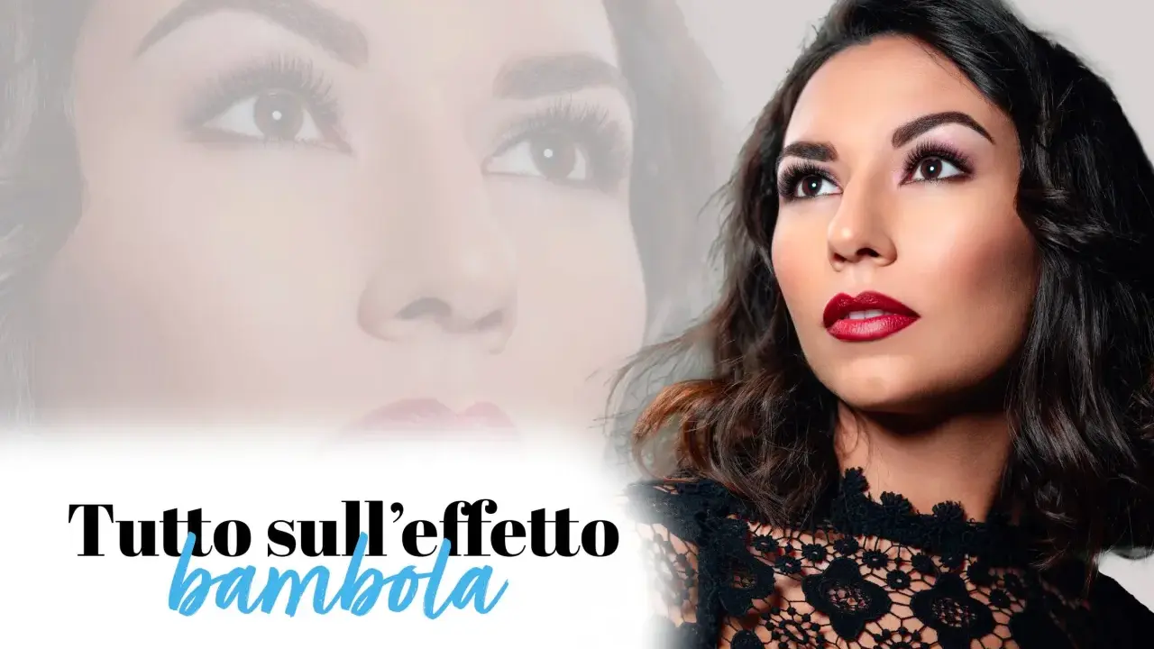 Un trucco per ciglia che dona uno sguardo da bambola. Labbra rosse e un abito di pizzo completano il look.