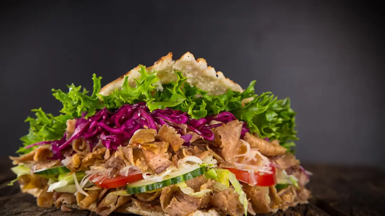 Saftiger Döner mit Fleisch, Salat, Tomaten, Gurken und Rotkohl. Perfekt, um Kebab selber machen zu lernen!